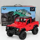 Camioneta RC Land Rover roja y caja.webp